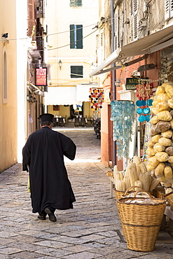 Greek Orthodox priest in traditional robes in street scene in Kerkyra, Corfu Town, Corfu, Greek Islands, Greece, Europe