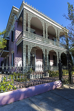 Traditional grand mansion house with ornate wrought iron in the Garden District of New Orleans, Louisiana, USA