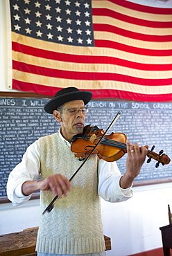 Violinist playing violin at Vermilionville history museum of Acadian, Creole, Native American cultures, Lafayette, Louisiana USA