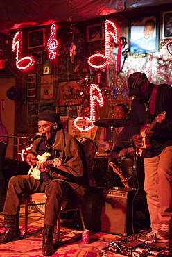 Blues band, guitarist, drums, vocals in live performance on stage at Red's Lounge Blues Club in Clarksdale, Mississippi, USA