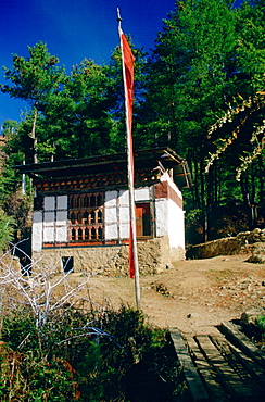 Farmer's home with prayer flags, Bhutan