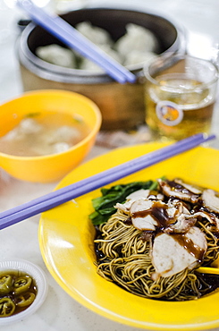 Pork noodles (mee), served with pickled chillies, a broth, wontons and beer, at Taman Dessa food court, Kuala Lumpur, Malaysia, Southeast Asia, Asia 