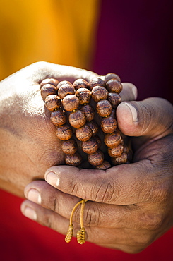 A Buddhist monk holds prayer beads (Japa Mala), Bodhnath, Nepal, Asia