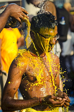 A devotee washes after participating in Thaipusam festival, Batu Caves, Kuala Lumpur, Malaysia, Southeast Asia, Asia 