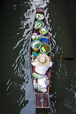 A vendor paddles their boat, Damnoen Saduak Floating Market, Thailand, Southeast Asia, Asia 