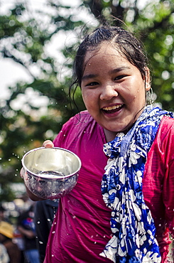 A girl with a traditional blessing bowl during Songkran water festival celebrating Thai New Year, Chiang Mai, Thailand, Southeast Asia, Asia