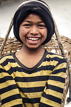 A boy carrying a doko (head basket), Tolka, Annapurna Conservation Area, Nepal, Asia