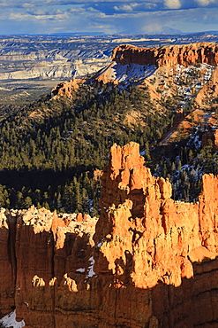 Late afternoon sun lights hoodoos and rocks through a cloudy sky in winter, Sunset Point, Bryce Canyon National Park, Utah, United States of America, North America