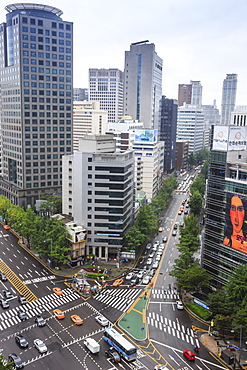 Elevated view of a busy city centre street and high rise buildings on a rainy summer day, City Hall area, Seoul, South Korea, Asia