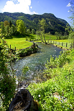 View of river and meadow in Lungau, Austria