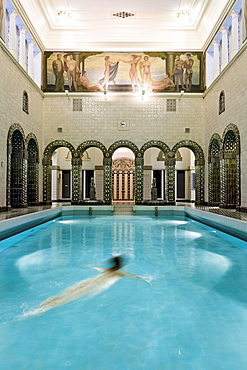 Woman swimming in Emperor Frederick swimming pool, Wiesbaden, Hesse, Germany