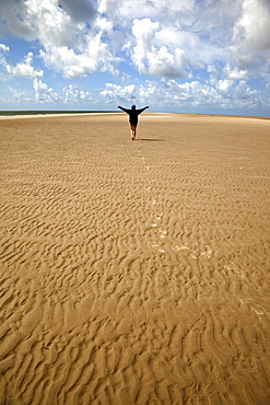 Person walking on the rippled sand at Fano beach, Denmark