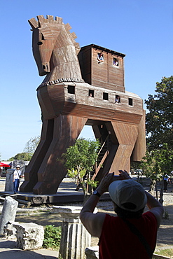 Tourist clicking photographs of Trojan horse in Troy, Turkey