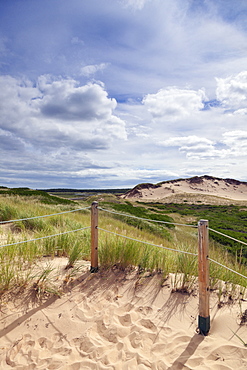 Close-up of sand dunes with wire fence in Prince Edward Island National Park, Canada