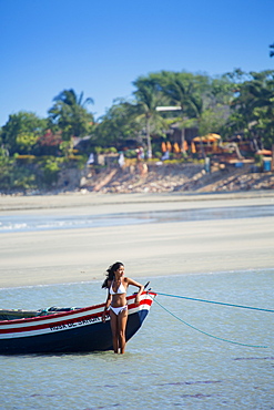 A young woman on the beach in Jericoacoara, Ceara, Brazil, South America