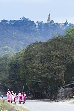 Buddhist nuns in traditional robes with the stupas of Sagaing in the distance, Sagaing, Myanmar (Burma), Southeast Asia