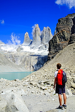 Hiker in front of the rock towers that give the Torres del Paine range its name, Torres del Paine National Park, Patagonia, Chile, South America