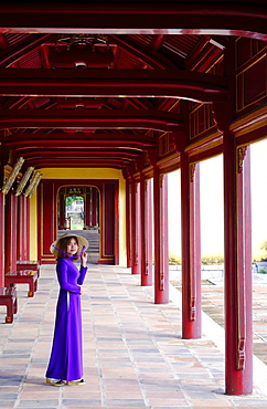 A woman in a traditional Ao Dai dress and Non La conical hat in the Forbidden Purple City of Hue, UNESCO World Heritage Site, Thua Thien Hue, Vietnam, Indochina, Southeast Asia, Asia