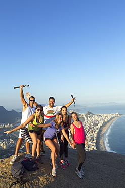 Local tourists on the summit of Dois Irmaos peak (Two Brothers Peak) with Ipanema, Corcovado and Rio city below, Rio de Janeiro, Brazil, South America