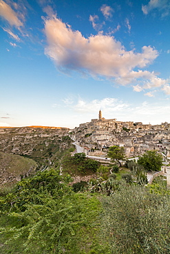 Sunset on the ancient town and historical center called Sassi, perched on rocks on top of hill, Matera, Basilicata, Italy, Europe