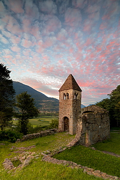 Pink clouds at sunset on the old Abbey of San Pietro in Vallate, Piagno, Sondrio province, Lower Valtellina, Lombardy, Italy, Europe