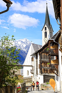 Bicycles in the old town framed by snowy peaks, Guarda, Inn District, Lower Engadine, Canton of Graubunden, Switzerland, Europe