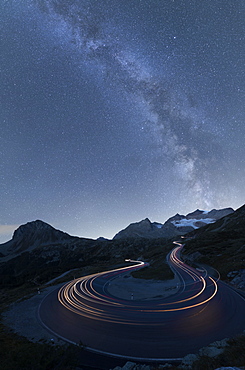 Milky Way and lights of car traces, Bernina Pass, Poschiavo Valley, Engadine, Canton of Graubunden, Switzerland, Europe