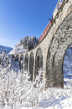 Bernina Express train on Landwasser Viadukt, UNESCO World Heritage Site, Filisur, Albula Valley, Canton of Graubunden, Switzerland, Europe