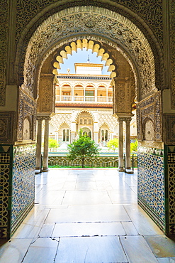 Patio de las Doncellas from interior of a room decorated with mosaic tiled and archways, Real Alcazar, UNESCO World Heritage Site, Seville, Andalusia, Spain, Europe