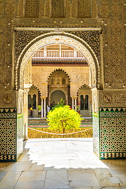 Patio de las Doncellas from interior of room with arabic mosaic walls and archways, Real Alcazar, UNESCO World Heritage Site, Seville, Andalusia, Spain, Europe