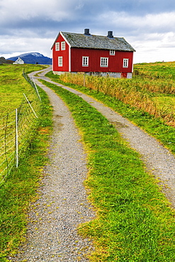 Red wooden house and country road in Flakstad, Lofoten Islands, Norway, Europe