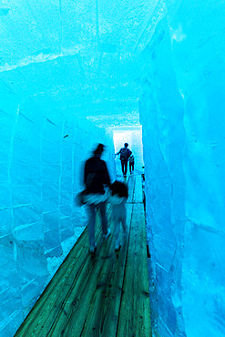 Tourists walking in the ice grotto inside Rhone Glacier, Gletsch, Canton of Valais, Switzerland, Europe