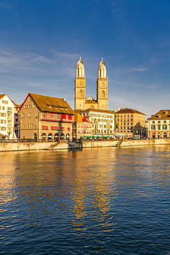 Sunset over Grossmunster Cathedral and Limmatquai street along the banks of Limmat River, Zurich, Switzerland, Europe