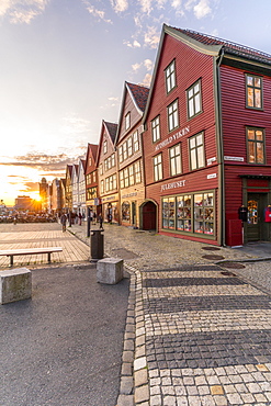 Sunset over cobblestone street and old buildings in Bryggen, UNESCO World Heritage Site, Bergen, Hordaland County, Norway, Scandinavia, Europe