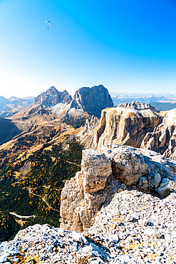 Paragliding over Sassolungo, Sassopiatto and Sella Pass in autumn seen from Sass Pordoi, Dolomites, Trentino, Italy, Europe