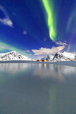 Northern Lights (aurora borealis) reflected in the cold waters, Flakstad, Lofoten Islands, Arctic, Norway, Scandinavia, Europe