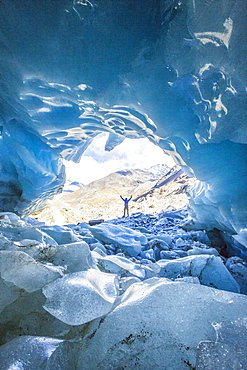 Hiker inside Forni Glacier, Forni Valley, Stelvio National Park, Valtellina, Lombardy, Italy, Europe