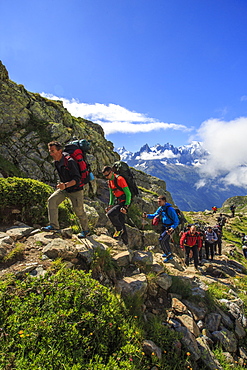 Hikers on the rocky paths around Lac De Cheserys on a sunny summer morning, Chamonix, Haute Savoie, French Alps, France, Europe