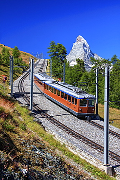 The swiss Bahn train runs on its route with the Matterhorn in the background, Gornergrat, Canton of Valais, Swiss Alps, Switzerland, Europe