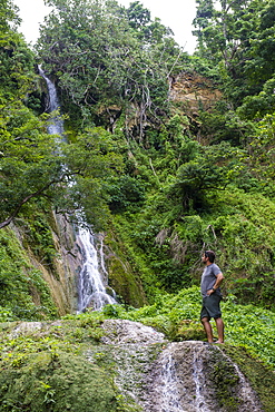 Man standing underneath the Mele Cascades, Efate, Vanuatu, Pacific