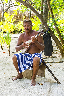 Local man playing the Ukulele, Bora Bora, Society Islands, French Polynesia, Pacific