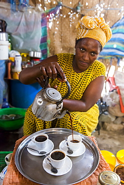 Woman serving Ethiopian coffee, Danakil depression, Ethiopia, Africa