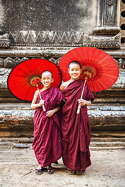 Two young monks and traditional umbrellas, Bagan (Pagan), Myanmar (Burma), Asia