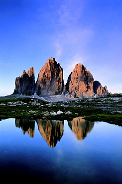 Dolomites, italy. South tyrol. Area of the three chimneys,from left to right: small chimney 2857 m; big chimney 2999 m; western chimney 2973 m; reflecting in a small puddle of water