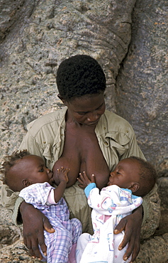 Ghana woman feeding twins bongo, bolgatanga