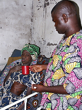 Gambia victim monica being cared for by nurse saidyba, birkama