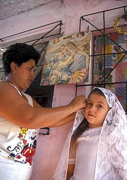 El salvador nother adjusts girls first communion dress, san salvador.