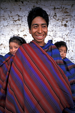 Guatemala father & daughters display a sample of his weaving, (benjamen gomex, of man)