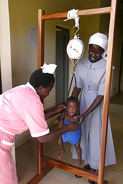 UGANDA St Monica's clinic Gulu. Weighing a baby. PHOTO by Sean Sprague