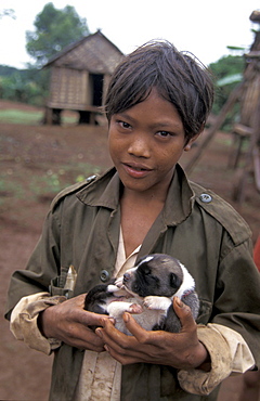 Cambodia ra, 11, holding a puppy. village, ratanakiri.